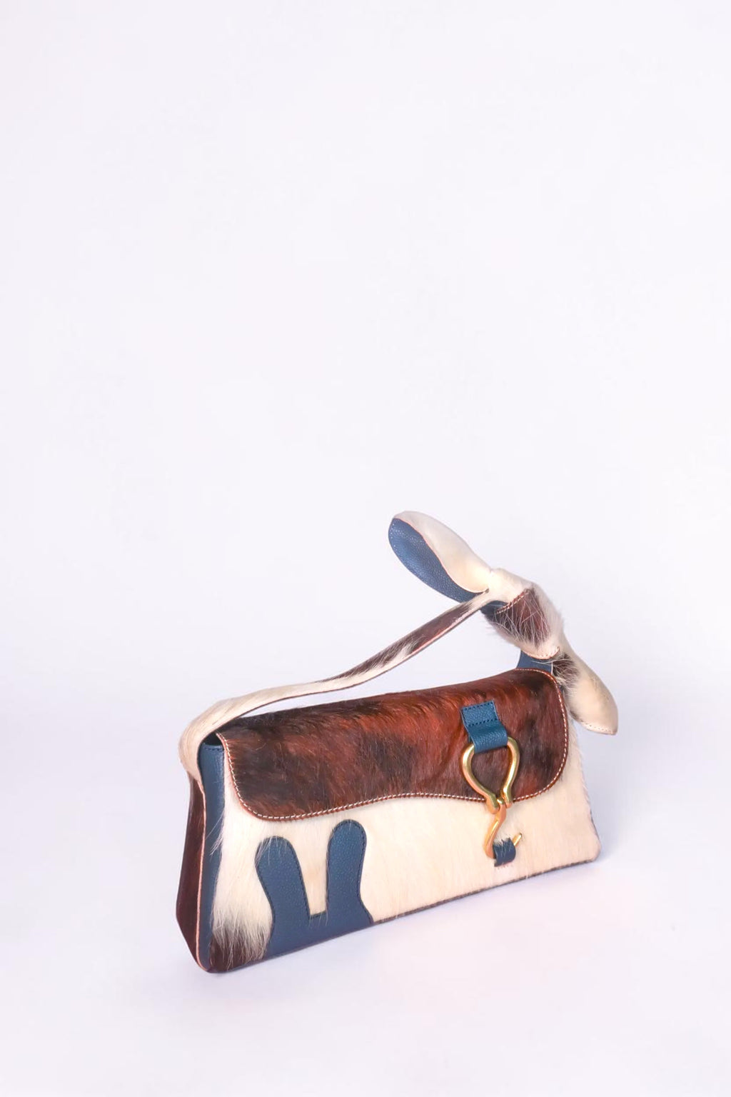 design Girls World blue & fur bunny ears shoulder bag made of cowhide leather and cotton. Features a leather bow and bunny logo.