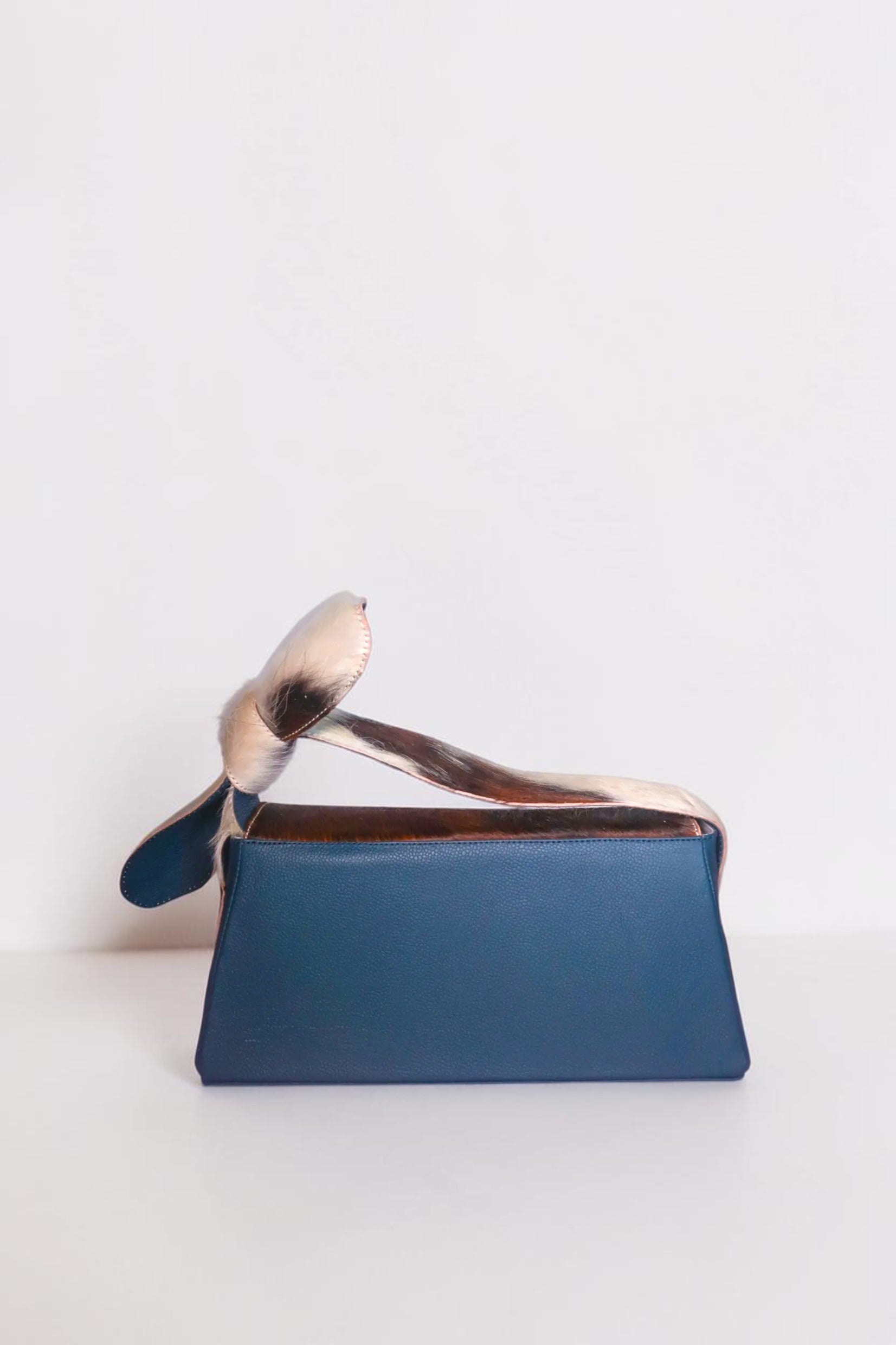 Design Girls World blue leather mini box bag with fur trim and bunny ears detail, perfect for date night.