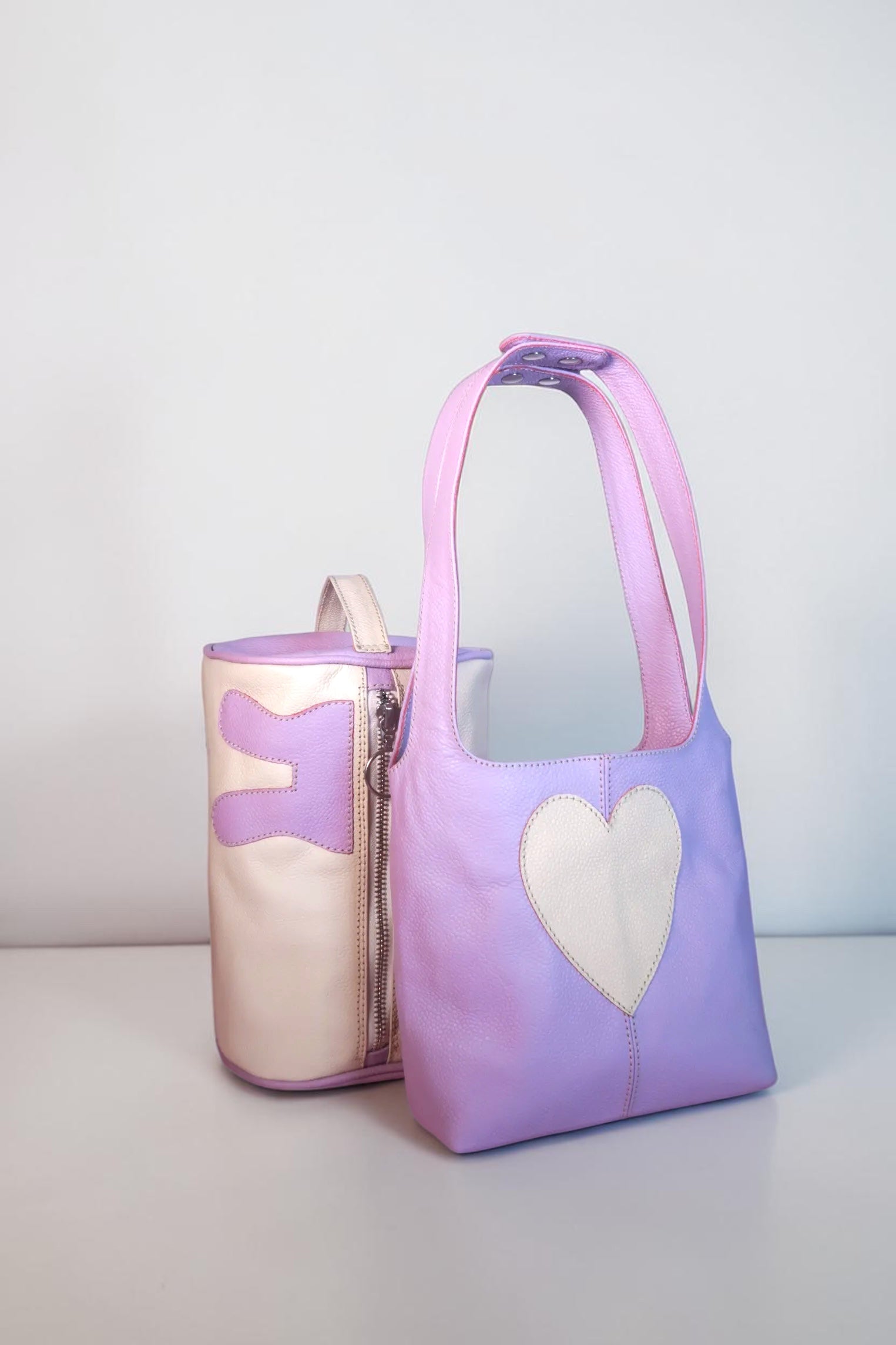 Design Girls World lavender and cream leather mini tote bag with heart detail and matching cosmetic bag.