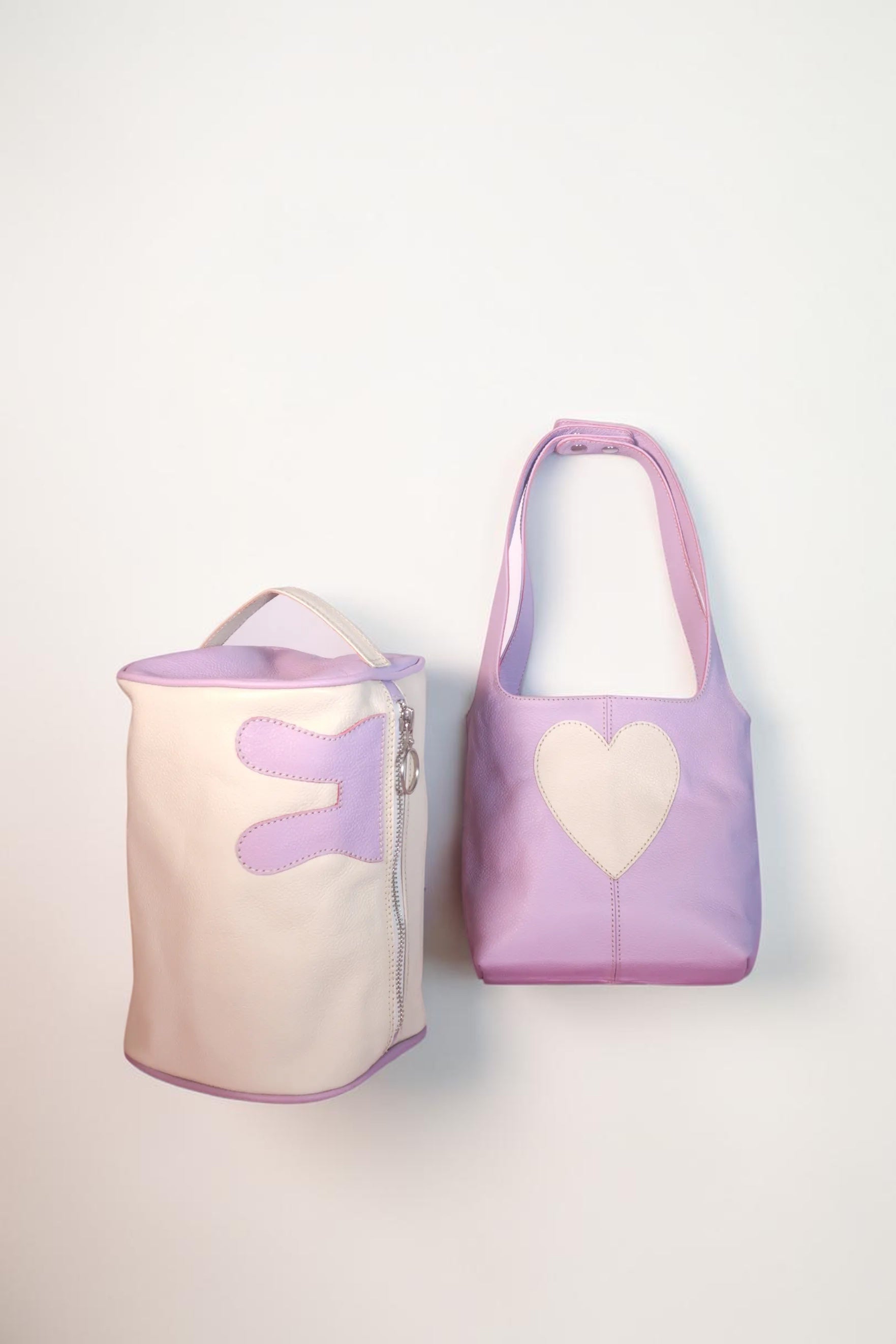 Design Girls World Mommy & Me lavender mini tote and cosmetic bag set. The tote has a heart detail. The cosmetic bag has bunny ear details.