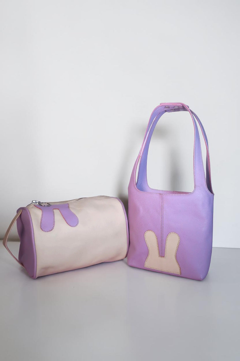 Design Girls World Mommy & Me lavender leather tote bag and cosmetic bag set with bunny details.